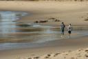 Jensen and Kent
          running on the beach